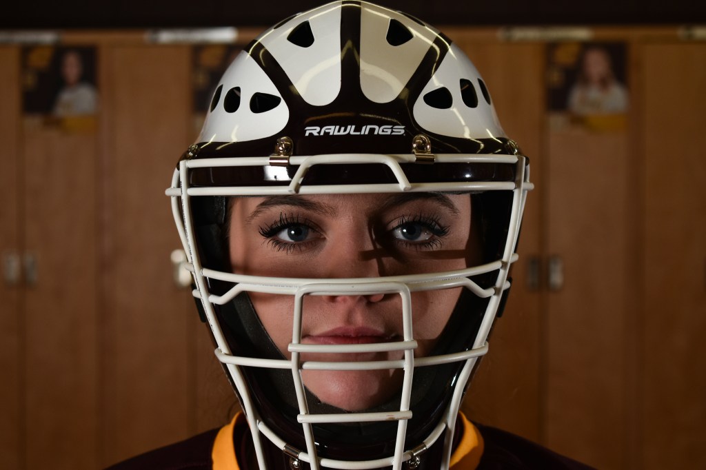 Katie Sexton poses in the CMU Women's Softball Lockerroom in Rose Arena on the campus of Central Michigan University, Sunday, Dec. 4, 2022. This is Katie's third year as a catcher on the team.